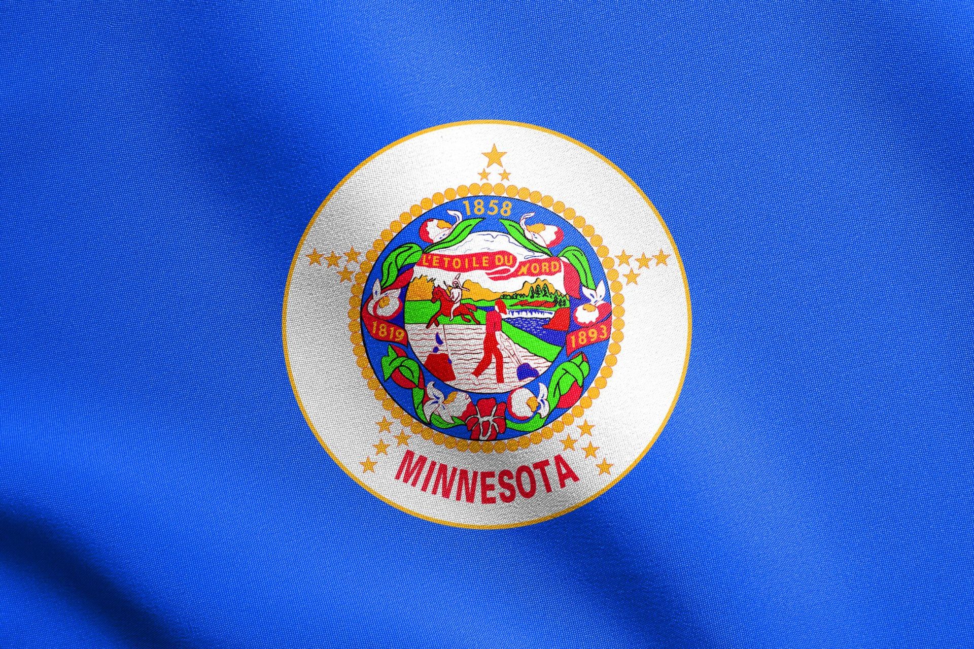 The Minnesota state flag which connects to how truckers should get Minnesota truck insurance.