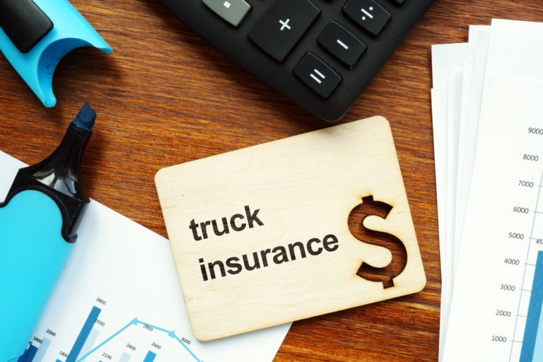 An image of a truck insurance sign with a dollar sign next to it.