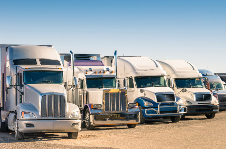 An image of a fleet of semi trucks covered by truck insurance.